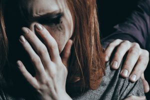 What to Do If Someone Is Suicidal - hand on shoulder of depressed girl