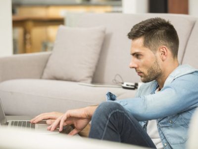 7 Ways to Help You Get Your Career Back on Track: Job Hunting Tips for People in Recovery - young man in living room on laptop