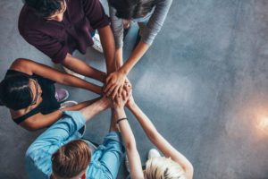 12 step alternatives, Alternatives to 12-Step Addiction Recovery, Alternative Treatment Approaches, 6-Alternatives-to-12-Step-Groups-Finding-the-Support-You-Need-to-Stay-Sober - five people with hands on top of each other in circle