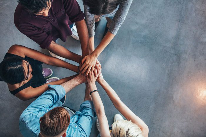6-Alternatives-to-12-Step-Groups-Finding-the-Support-You-Need-to-Stay-Sober - five people with hands on top of each other in circle