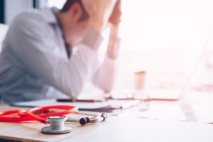 Successful-People-Can't-Escape-Addiction's-Grip - young doctor stressed out