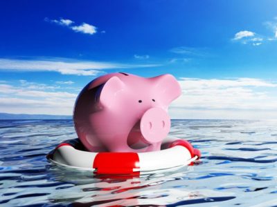 piggy bank on lifesaver in water - addiction treatment