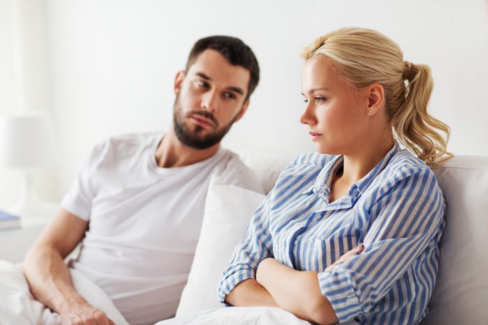 young couple looking upset - spouse's addiction