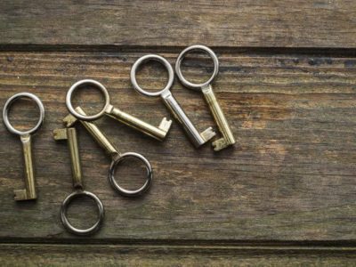6 old fashioned metal keys laying on wooden table - life