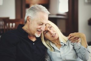 senior couple talking on couch - your recovery