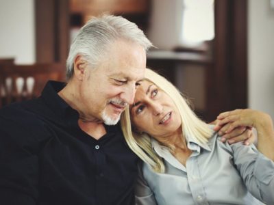 senior couple talking on couch - your recovery