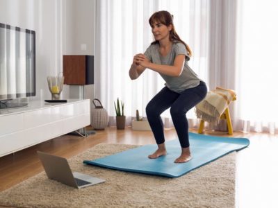 middle age woman doing exercises at home - uncertainty