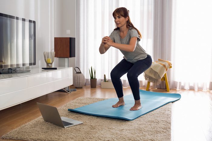 middle age woman doing exercises at home - uncertainty