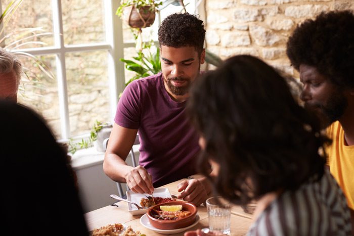 diverse friends or family sharing a meal - building relationships