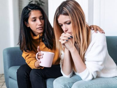 young woman consoling her friend - hydrocodone addiction