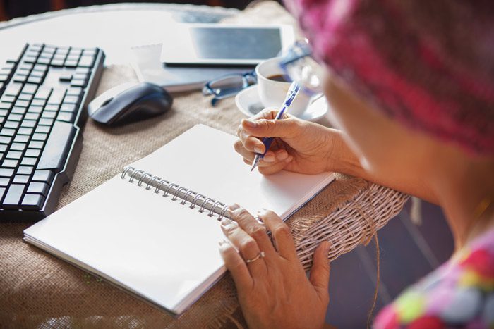 woman writing in her recovery journal