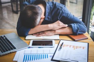 Alcohol and Insomnia: How Alcohol Affects Sleep, middle age man asleep on his work desk - insomnia