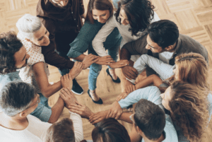 A group of people with their arms locked.