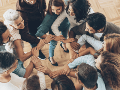 A group of people with their arms locked.