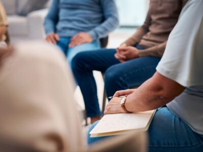 Diverse Group of People Attending a Support Group Meeting Indoors in Casual Attire
