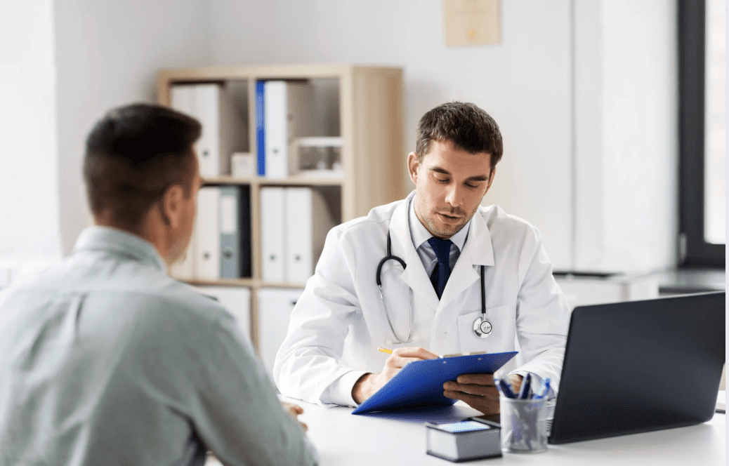 A male patient talking to a doctor.