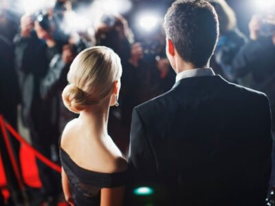 Celebrities posing for paparazzi on red carpet