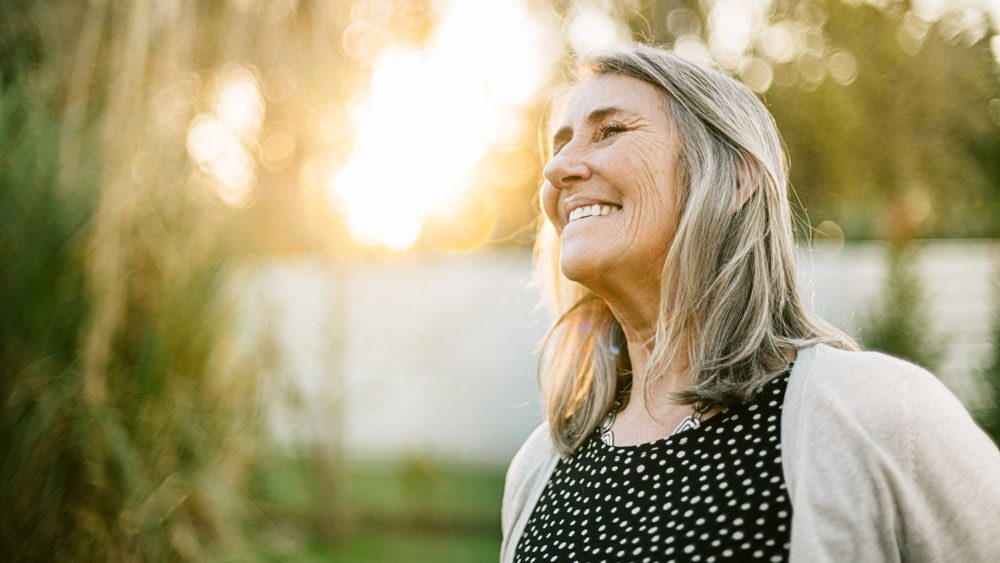 portrait of an older woman smiling outdoors
